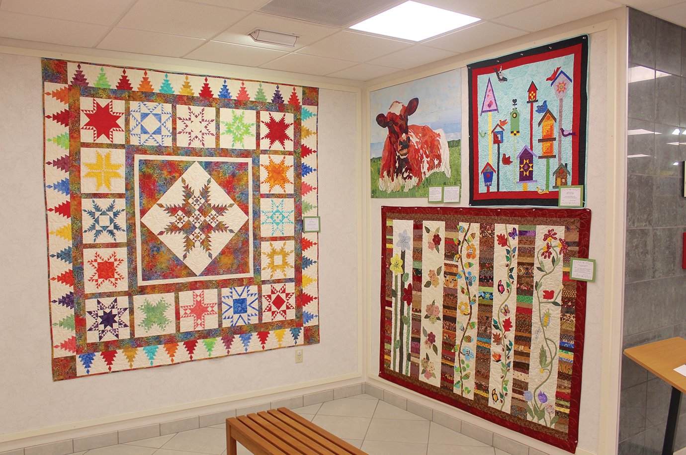 Quilts and crafts created by the Sugar Creek Quilters Guild adorn the west wall of the Crawfordsville District Public Library as the latest exhibit in the Mary Bishop Memorial Gallery.